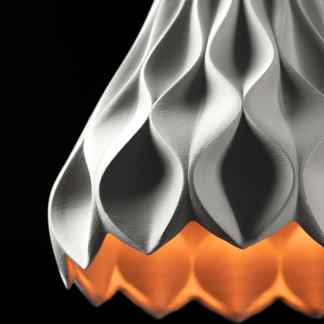 A detailed close-up of a 3D printed futuristic lamp with metallic finish, showcasing complex geometric patterns and modern design.