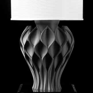Sleek modern table lamp with intricate 3D-printed geometric base and stylish lampshade for contemporary interiors.