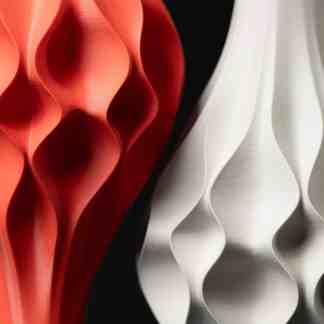 Close-up of modern 3D printed abstract art in vibrant red and sleek white finishes.