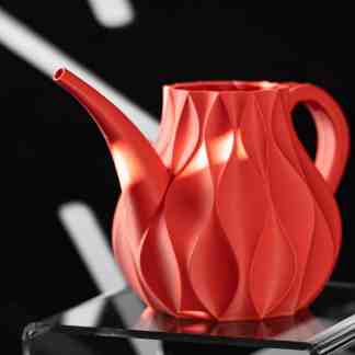 Highly detailed red 3D-printed teapot showcasing modern design.
