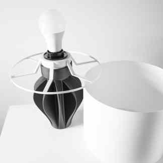 Minimalist black and white 3D printed lamp with modern geometric shapes and sleek design.