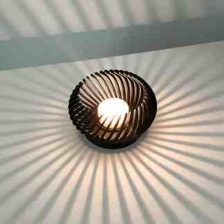 Elegant wooden ceiling lamp creating artistic shadows for stylish lighting.
