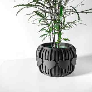 Black 3D-printed flowerpot with heart-shaped cutouts, perfect for home decor.