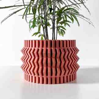 Stylish pink 3D-printed geometric flower pot with detailed pattern, ideal for contemporary home styling.