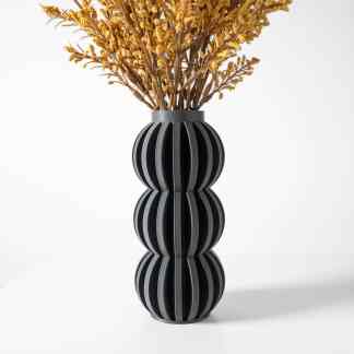 3D printed black vase with yellow flowers, stylish modern decor piece for home or office.