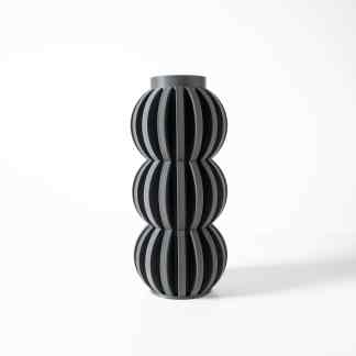 3D printed black geometric vase with sleek, artistic curves.