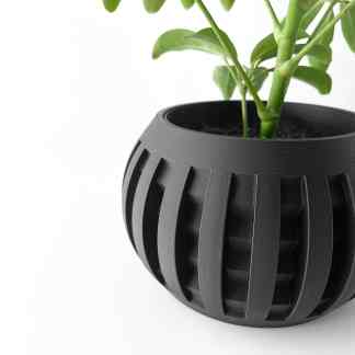 Black 3D printed plant pot with geometric cutouts for stylish indoor decor.