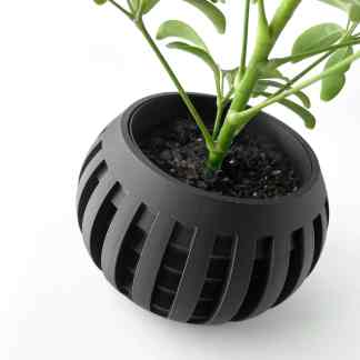 Black 3D printed planter for indoor plants, showcasing innovative design and durable material.