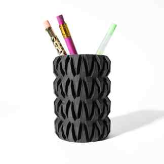 3D printed black pen holder with geometric pattern and three colorful pens.