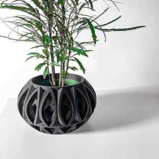 A modern black 3D-printed geometric plant pot with a plant inside, highlighting innovative design and 3D printing technology.