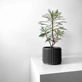 Stylish black 3D-printed plant pot with textured geometric design, perfect for contemporary interior styling.