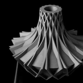 A black-and-white 3D printed turbine sculpture emphasizing precision and innovative design.