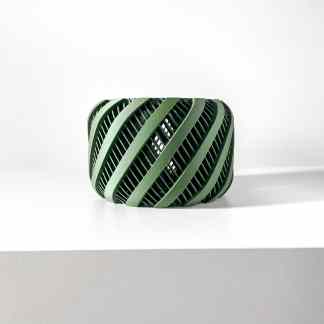 3D printed geometric sculpture with layered, diagonal design in green.
