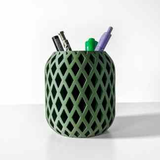 Stylish green pen holder with perforated pattern holding pens and markers for office use.