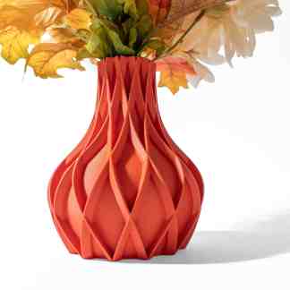 3D printed orange vase with geometric cutouts, ideal for modern home decor and floral arrangements.