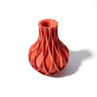 Bright orange 3D printed vase with intricate layered pattern, showcasing advanced 3D printing technology.