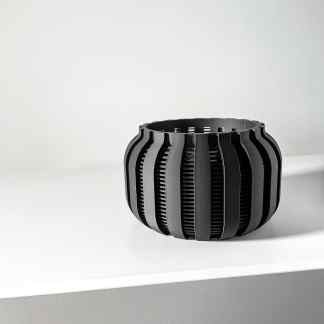 High-quality 3D-printed modern geometric black object on white surface, showcasing innovative design.