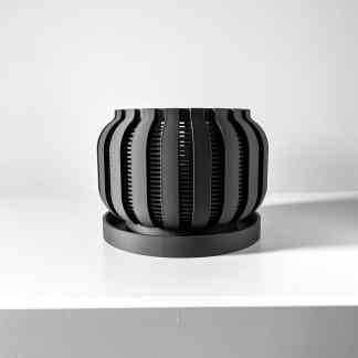 Modern black and gray 3D printed art piece with sleek, curved patterns.