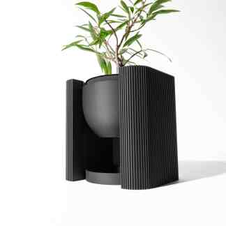 Stylish black planter with textured panels holding a green plant, ideal for modern indoor spaces.