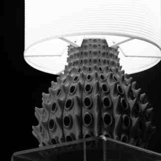 Stylish black and white lamp featuring a textured base and sleek white lampshade, perfect for contemporary interior decor.