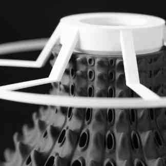 Highly detailed 3D-printed drone part with white frame and textured black base.