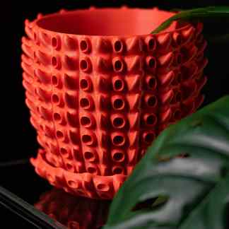 Vase crafted using 3D printing technology with a modern, textured hollow structure for home decor.