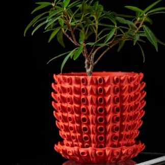 Vivid red 3D-printed flower pot with distinctive textured pattern, showcasing advanced additive manufacturing technology.