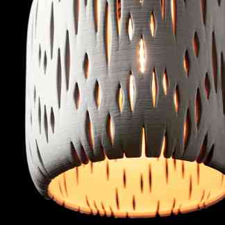 Close-up of a stylish 3D-printed lamp featuring detailed cut-out designs and warm interior glow for modern decor.