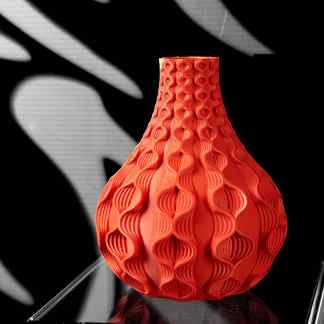 Vibrant orange 3D printed vase with intricate geometric design and textured surface.
