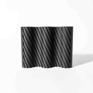 A black 3D-printed abstract sculpture featuring diagonal ridges, highlighting innovative 3D printing and digital art.