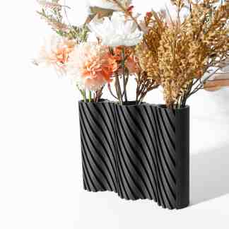 Decorative 3D printed modern black vase with textured wave design.