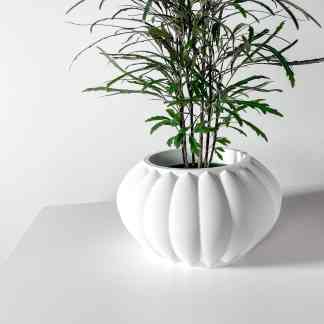 Stylish white 3D-printed geometric flowerpot with lush green indoor plant, perfect for contemporary interior design.