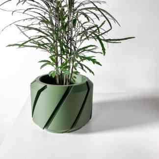 3D printed green plant pot with detailed design and plant foliage, ideal for modern indoor decor.
