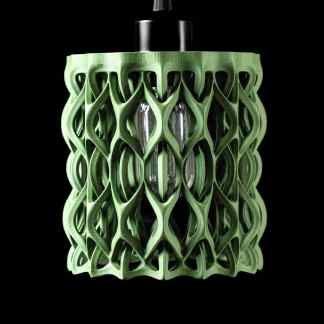 Intricate green 3D-printed LED lamp with modern, artistic structure on black background.