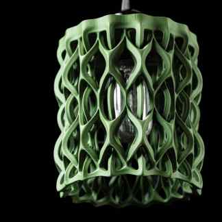 Intricate green 3D-printed lamp with a futuristic lattice structure, showcasing innovative Additive Manufacturing technology.