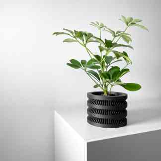 3D printed black geometric planter with modern design, ideal for homes and offices.