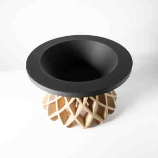 A modern 3D printed table with a black top and an intricate beige geometric base.