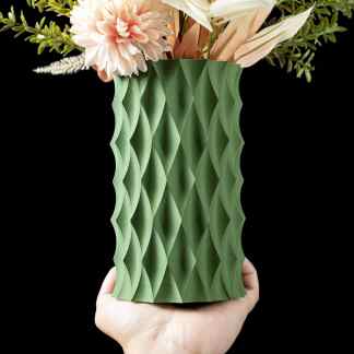 A 3D printed green vase showcasing intricate geometric patterns, holding flowers for elegant decor.
