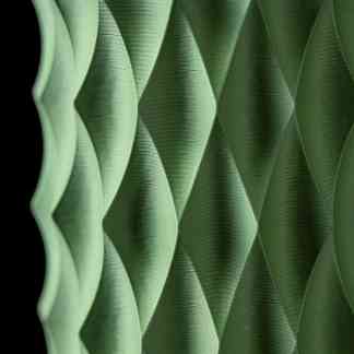 Detailed view of a green 3D printed honeycomb pattern, showcasing advanced additive manufacturing techniques.