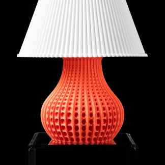 Detailed 3D printed orange lamp base showcasing advanced additive manufacturing technology.