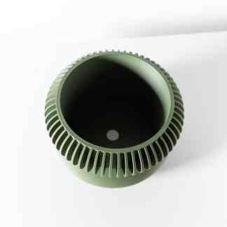 Close-up of a green 3D-printed gear with detailed teeth and hollow center.