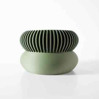 3D-printed green decorative sculpture with detailed ribbed design highlighting modern additive manufacturing techniques.
