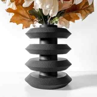 Black 3D-printed vase with intricate design details and floral decoration, emphasizing modern 3D printing craftsmanship.