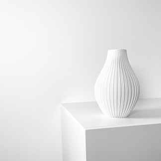 Elegant 3D printed white ceramic vase with textured vertical lines, modern home decor piece.