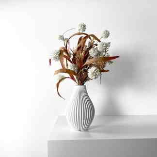 Minimalist 3D printed white vase with dried flowers, perfect for modern interior decoration and artistic displays.