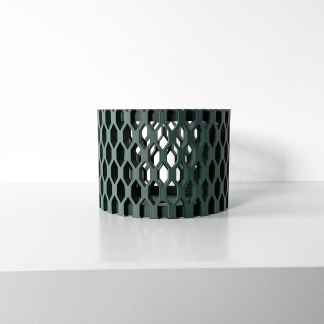 Stylish 3D-printed dark green geometric mesh container on a white surface.