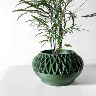 A stylish green 3D-printed geometric vase holding a leafy plant, perfect for contemporary interior design.