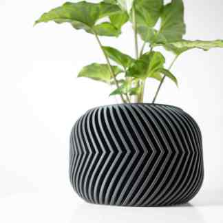 3D printed plant vase with sleek black geometric design for modern home decor.
