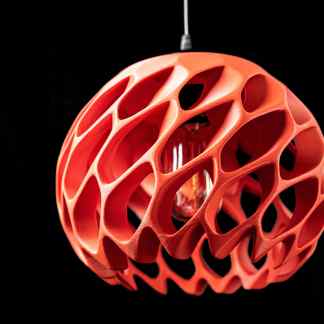 Alt text: Modern 3D-printed pendant lamp with intricate geometric design in red.