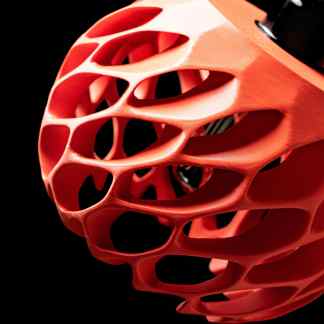 High-quality 3D printed geometric lattice structure in coral on black background, showcasing innovative design and modern technology.